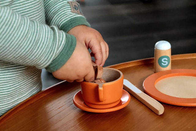Parent and child arranging wooden toys on a low shelf in a calm Scandinavian playroom